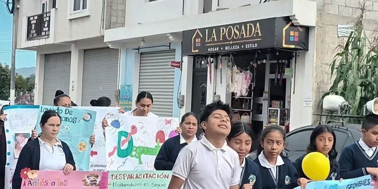 Personal del Ministerio de Salud aplicando vacunas y entregando desparasitantes a estudiantes en una escuela de Quetzaltenango.